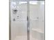 Modern shower features glass doors, a shower caddy, and a built-in bench at 545 Tourmaline Dr., Little River, SC 29566