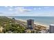 Breathtaking aerial view of a beach community with a high-rise building and ocean views at 5523 N Ocean Blvd. # 1101, Myrtle Beach, SC 29577