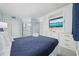 This bright main bedroom features a large comfortable bed, soft blue accents, and a TV set in custom shelving at 5523 N Ocean Blvd. # 1101, Myrtle Beach, SC 29577