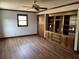 Spacious bedroom with built-in shelving, hardwood floors, dark trim, and plenty of natural light at 5704 Woodside Ave., Myrtle Beach, SC 29577