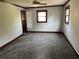 Empty bedroom with blue carpet, dark trim, and lots of natural light at 5704 Woodside Ave., Myrtle Beach, SC 29577