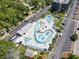 Aerial view of community pool and amenity area surrounded by lush landscaping and parking at 5905 S Kings Highway # 416-A, Myrtle Beach, SC 29575