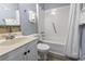 This bright bathroom offers a shower-tub and a white vanity with marbled countertops at 5905 S Kings Highway # 416-A, Myrtle Beach, SC 29575
