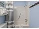 The bright bathroom has a white shower-tub, blue walls, and a striped shower curtain at 5905 S Kings Highway # 416-A, Myrtle Beach, SC 29575