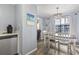 Dining area with modern light fixture and view of the outside balcony at 5905 S Kings Highway # 416-A, Myrtle Beach, SC 29575