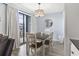 Cozy dining area featuring modern light fixture and view of the balcony at 5905 S Kings Highway # 416-A, Myrtle Beach, SC 29575