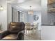 Open dining area with modern light fixture and view of wet bar and living area at 5905 S Kings Highway # 416-A, Myrtle Beach, SC 29575