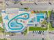 An aerial view of a community swimming pool, parking area, and palm tree landscaping at 5905 S Kings Hwy. # 216B, Myrtle Beach, SC 29577