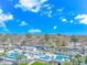 An aerial view of community pool and surrounding area with palm trees and landscaping near the beach at 5905 S Kings Hwy. # 216B, Myrtle Beach, SC 29577