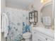 Clean bathroom with a vanity, nautical decor, and stylish coral-themed shower curtain for relaxation at 5905 S Kings Hwy. # 216B, Myrtle Beach, SC 29577