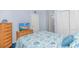 Cozy bedroom featuring ocean themed bedding, a TV, and dresser, perfect for a restful night's sleep at 5905 S Kings Hwy. # 216B, Myrtle Beach, SC 29577