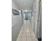 Bright hallway with tile flooring and panel walls leading to a comfortable living area at 5905 S Kings Hwy. # 216B, Myrtle Beach, SC 29577