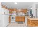 Functional kitchen with wooden cabinets, white appliances, and ample counter space at 5905 S Kings Hwy. # 216B, Myrtle Beach, SC 29577