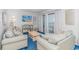 Comfortable living room with sofas, beach-themed decor, and balcony access at 5905 S Kings Hwy. # 216B, Myrtle Beach, SC 29575