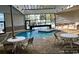 Indoor pool area featuring a hot tub, tables, and lounge chairs, perfect for relaxation and recreation at 5905 S Kings Hwy. # 216B, Myrtle Beach, SC 29577
