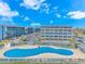 Aerial view of a large blue pool in front of buildings at 5905 S Kings Hwy. # 216B, Myrtle Beach, SC 29575