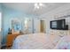 Inviting bedroom with a comfortable bed, TV, white dresser, and nautical decor at 6001- 1222 S Kings Highway, Myrtle Beach, SC 29575