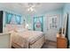 Bedroom with a cozy bed, light blue walls, and access to the outside at 6001- 1222 S Kings Highway, Myrtle Beach, SC 29575