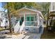 Inviting beach cottage featuring a charming front porch adorned with coastal decor and a vibrant turquoise door at 6001- 1222 S Kings Highway, Myrtle Beach, SC 29575