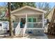 Delightful beach house showcasing a quaint porch with nautical accents and a vibrant turquoise door at 6001- 1222 S Kings Highway, Myrtle Beach, SC 29575