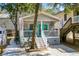 Charming beach house with a cozy front porch and vibrant turquoise door, creating a welcoming coastal ambiance at 6001- 1222 S Kings Highway, Myrtle Beach, SC 29575