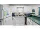 Kitchen with white appliances and cabinets, featuring green countertops and natural light at 6001- 1222 S Kings Highway, Myrtle Beach, SC 29575