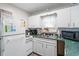 Bright kitchen with white appliances, cabinets, and green countertops at 6001- 1222 S Kings Highway, Myrtle Beach, SC 29575
