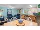 Comfortable living room with blue sofa and chair, complemented by woven barstools at the kitchen counter at 6001- 1222 S Kings Highway, Myrtle Beach, SC 29575