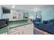 Open living space with a kitchen bar, comfortable seating, and access to an outdoor area at 6001- 1222 S Kings Highway, Myrtle Beach, SC 29575