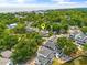 Aerial view of a house with a pin marker, nestled among lush trees and other homes in a charming neighborhood near the ocean at 6001 - Mh69B South Kings Hwy., Myrtle Beach, SC 29575