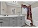 Bright bathroom featuring a double sink vanity, toilet, shower and tropical print window treatment and shower curtain at 6001 - Mh69B South Kings Hwy., Myrtle Beach, SC 29575