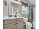 Neutral-toned bathroom features a vanity, toilet, bathtub, and shower with a decorative curtain at 6001 - Mh69B South Kings Hwy., Myrtle Beach, SC 29575