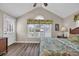Bedroom boasting a large window with tropical accents, wood floors, and a peaked ceiling at 6001 - Mh69B South Kings Hwy., Myrtle Beach, SC 29575