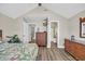 Spacious bedroom featuring wooden furniture, wood floors, and doorways to other rooms at 6001 - Mh69B South Kings Hwy., Myrtle Beach, SC 29575