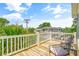 Outdoor deck area with chairs and glimpses of surrounding foliage and neighborhood buildings at 6001 - Mh69B South Kings Hwy., Myrtle Beach, SC 29575