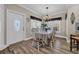 Charming dining room with chandelier, window views, and elegant decor at 6001 - Mh69B South Kings Hwy., Myrtle Beach, SC 29575