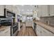 Spacious kitchen featuring white cabinets, stainless steel appliances, and an open view into the dining area at 6001 - Mh69B South Kings Hwy., Myrtle Beach, SC 29575