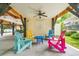 Casual gathering area featuring colorful Adirondack chairs and a small blue table, creating a welcoming space under the raised house at 6001 - Mh69B South Kings Hwy., Myrtle Beach, SC 29575