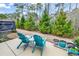 Outdoor patio seating area with blue Adirondack chairs surrounded by landscaping and beautiful scenery at 6013 Tramonto St., Myrtle Beach, SC 29577