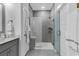 Modern bathroom features glass shower with a bench and gray tiling at 6013 Tramonto St., Myrtle Beach, SC 29577
