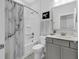 Bright bathroom featuring a shower-tub combo with marble patterned curtain and gray vanity with a white countertop at 6013 Tramonto St., Myrtle Beach, SC 29577