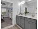 Bathroom vanity with double sinks, gray cabinetry and views to the bedroom and shower at 6013 Tramonto St., Myrtle Beach, SC 29577