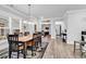 Bright dining room boasts a wooden table with six chairs and an area rug on light wood floors at 6013 Tramonto St., Myrtle Beach, SC 29577
