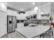 Modern kitchen with stainless steel appliances, white cabinets, mosaic tile backsplash, and a center island at 6013 Tramonto St., Myrtle Beach, SC 29577