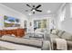 Bright living room with ceiling fan, neutral colored couches and view to screened patio at 6013 Tramonto St., Myrtle Beach, SC 29577