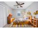 A room with a wooden bed frame and headboard, toys, gray walls and a ceiling fan at 602 Luttie Rd., Myrtle Beach, SC 29588