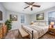 Charming bedroom featuring neutral walls, a ceiling fan, natural light, and a bed with a decorative floral blanket at 602 Luttie Rd., Myrtle Beach, SC 29588