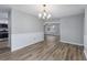 Open dining room with wood floors, neutral paint, and stylish chandelier at 602 Luttie Rd., Myrtle Beach, SC 29588