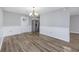 Empty dining room with modern lighting flowing into the kitchen with stainless steel appliances at 602 Luttie Rd., Myrtle Beach, SC 29588
