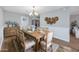 Charming dining room features a large wooden table, stylish decor, and access to the kitchen and living areas at 602 Luttie Rd., Myrtle Beach, SC 29588